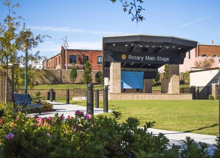 The covered amphitheatre stage at Central Park in Livingston, with the Hargrove and Mofield building on the rise behind it