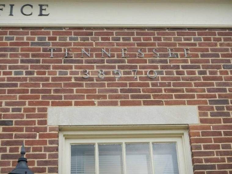 A brick building with the words 'Tennessee' and the number '38570' on it.