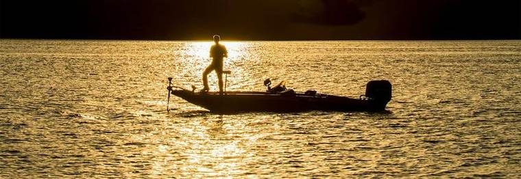 person fishing during sunset
