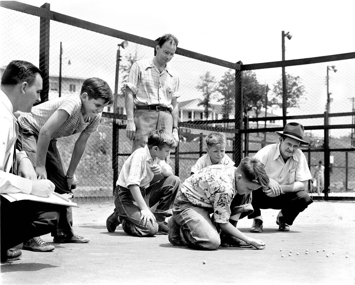 Children playing marbles at an organized marble tournament